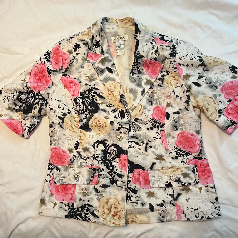 Short sleeve, pink and black floral print waist length jacket.